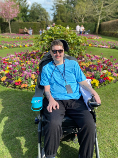 Rob in his chair infront of flowers