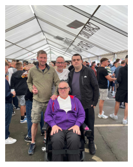 Liam in his power wheelchair inside the 'ideas tent' with three friends at Derby County football ground.