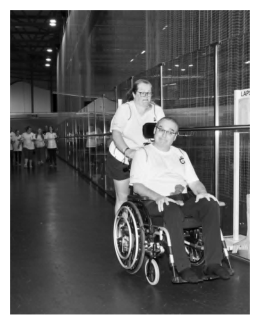 Liam in his wheelchair being pushed around the velodrome to complete a marathon.