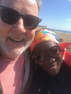 Rona and Adrian smile at the beach