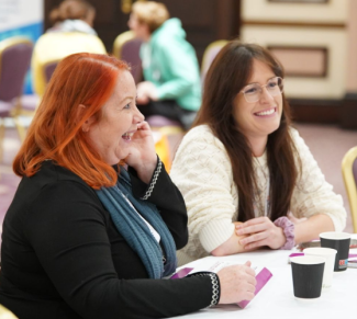 Two health and social care professionals smiling