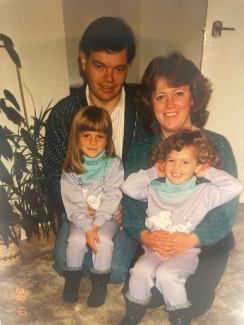 An old family photograph of Sarah and her sister Emma with their parents.