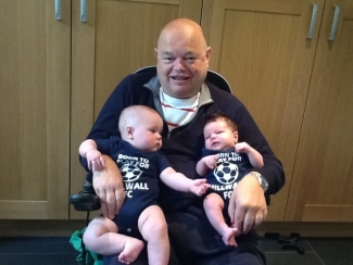 Sarah's dad with his two grandchildren.