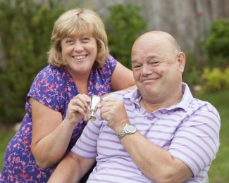 Sarah's mum and dad at a summer garden party.
