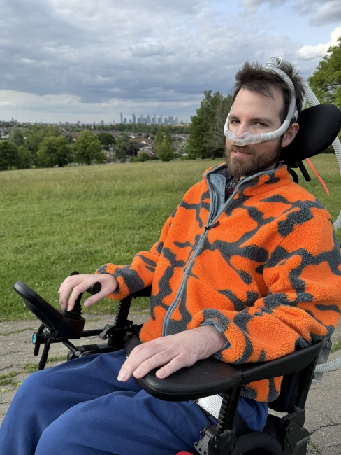 Alex in his powerchair outside