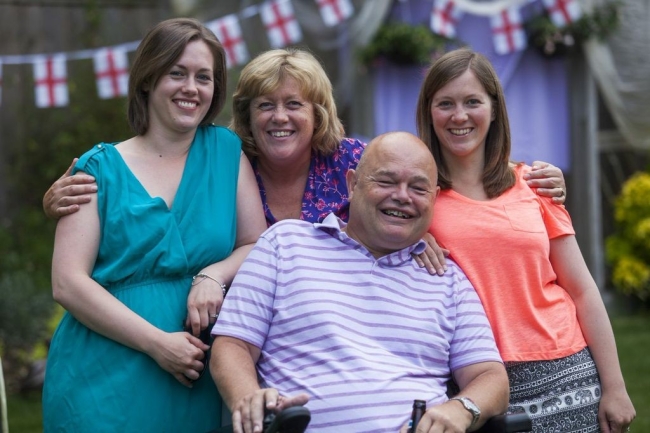 Sarah her sister Emma and their parents at a summer garden party. Sarah's dad is in an electric wheelchair.