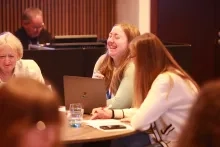 An early career researcher laughing.