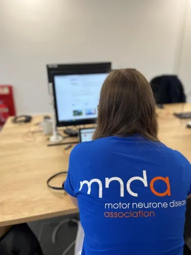 MND Association supporter at a computer
