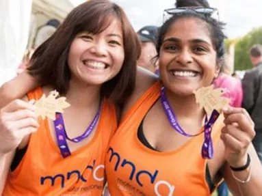 two people celebrating holding a medal
