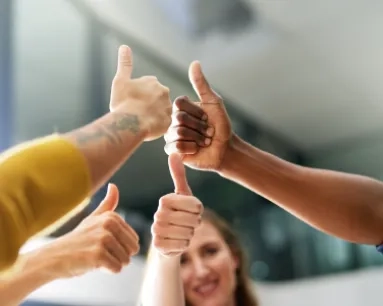 Hands with thumbs up, arranged in a circle.