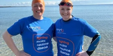 Two ladies ready for swimming with swim caps on