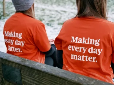 Two people sitting on a bench
