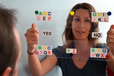 Two people using an E-tran frame to communicate