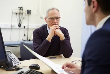 A GP talking to a patient with MND