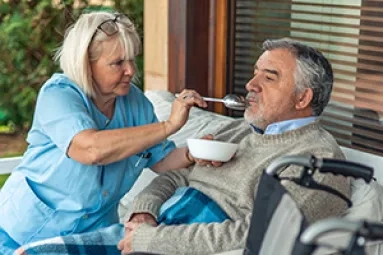 A professional feeding a person 