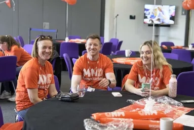 A group of volunteers sat at an event table