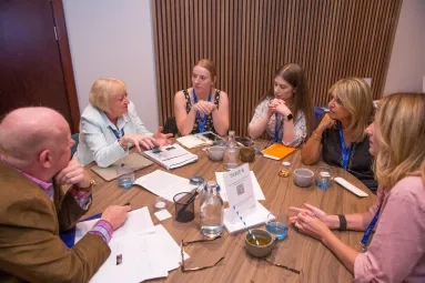 A group sat round a table at MND EnCouRage. 