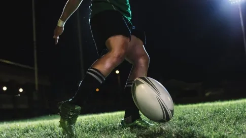 Rugby player kicking rugby ball