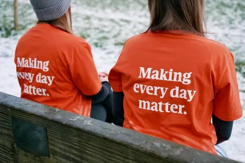 Two people in MND Association t-shirts