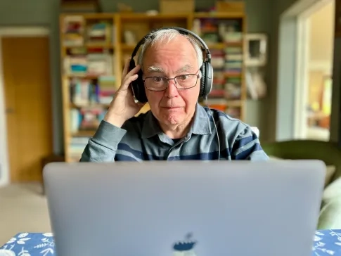 person sat behind laptop