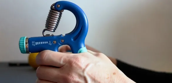 Someone using a grip strength tester