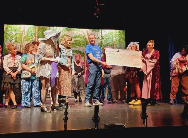 MNDA Hertfordshire volunteers presented with cheque by Variety Express on stage