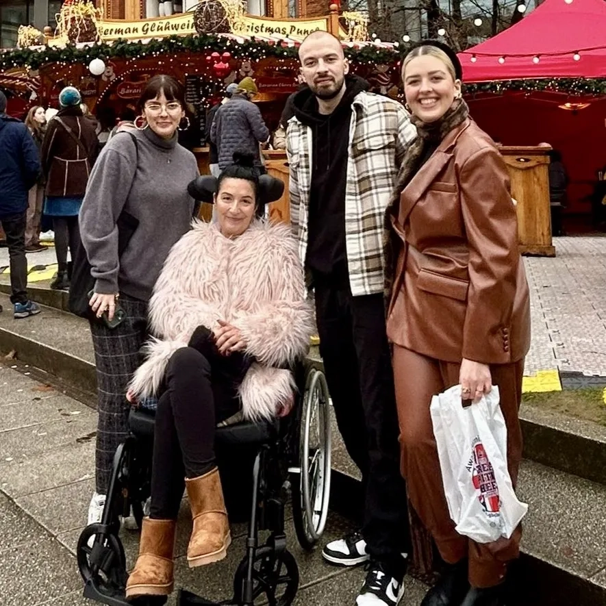 Debbie with her three grown up children, at a Christmas market.