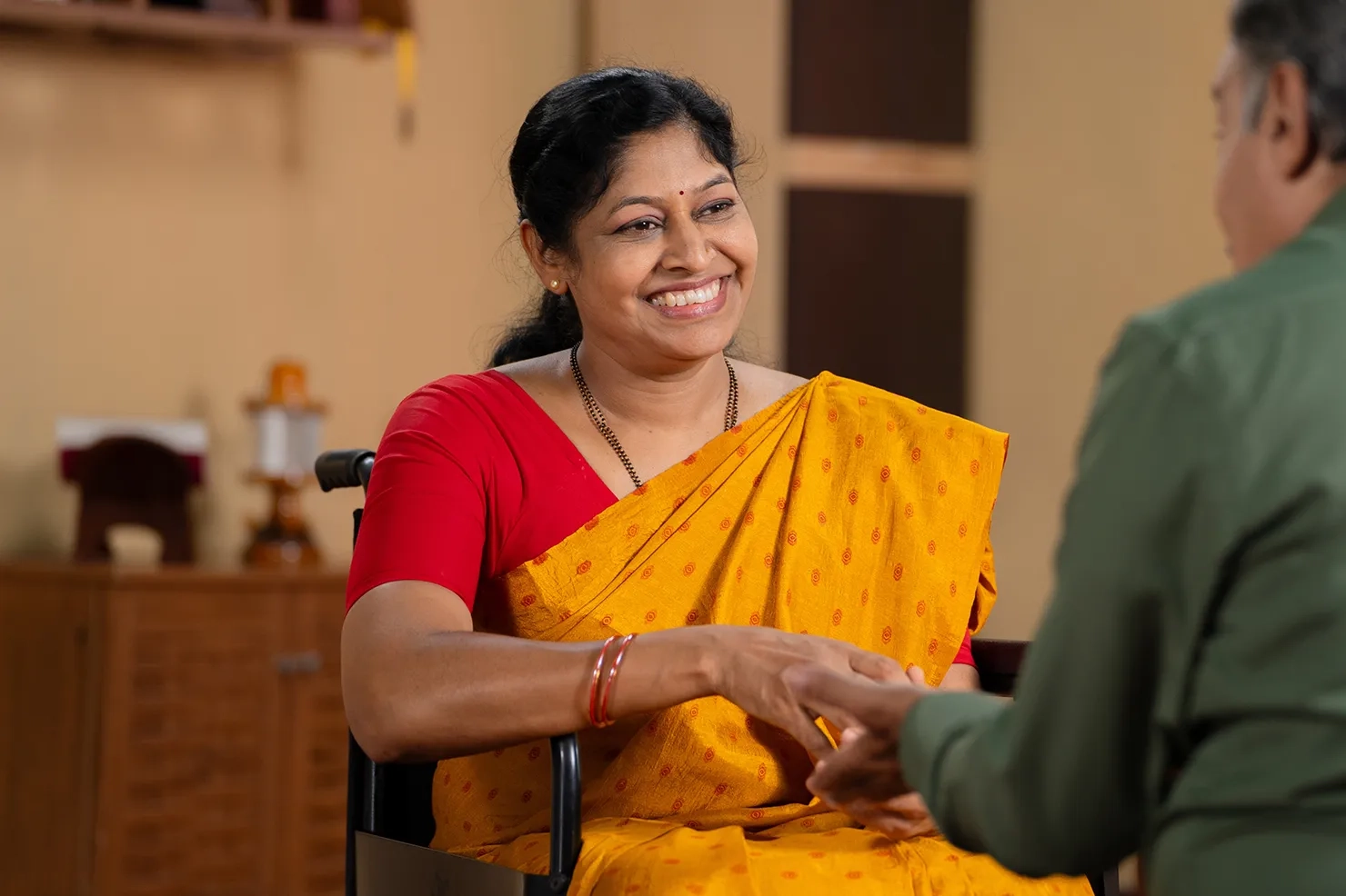 Woman holding a hand and smiling