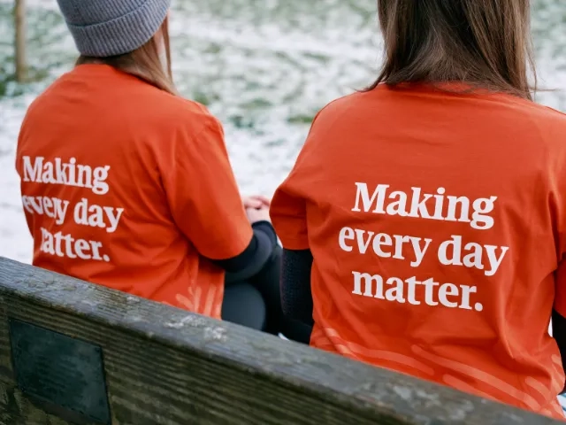 Two people sitting on a bench